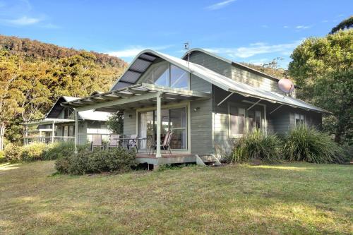 a house with a large window on the side of it at Valley Vista in Kangaroo Valley