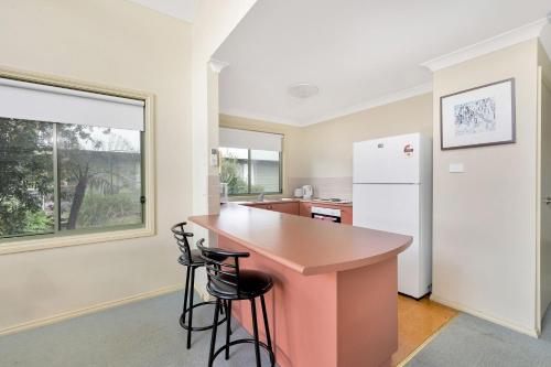 a kitchen with a pink counter and a refrigerator at Valley Vista in Kangaroo Valley