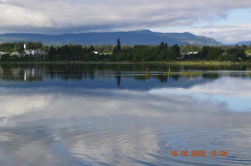 a large body of water with mountains in the background at Estuary House Reflexology B&B in Courtenay