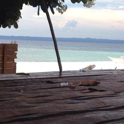 a view of the beach with the ocean in the background at Liwayway sa Bohol Pamilacan Resort in Baclayon