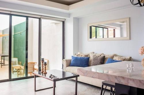 a living room with a couch and a table at Triton's Playhouse Beachfront in Primo Tapia