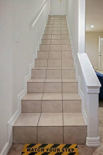 a stairway with a white railing and a stair case at 8 Mins to SPI Beach Spacious 3BR with Backyard in Port Isabel