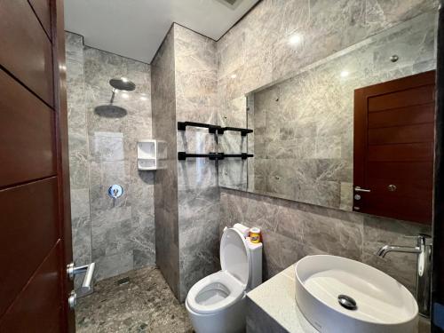 a bathroom with a toilet and a sink at Sandat Living in Canggu