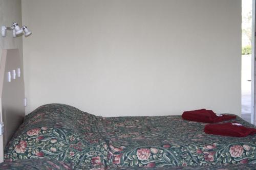 a bedroom with a bed with a blanket on it at Tenterfield Motor Inn in Tenterfield