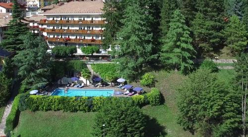 an aerial view of a hotel with a swimming pool at Hotel Miralago Wellness - Adults Only in Molveno