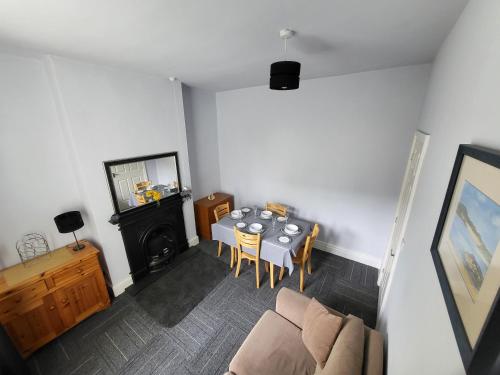 a living room with a table and a couch at 1 Lytham Terrace in Carnforth