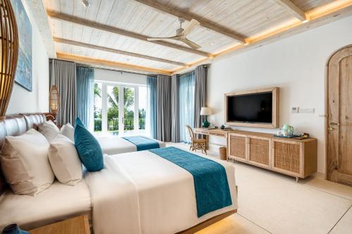 TV a/nebo společenská místnost v ubytování Stelia Beach Resort