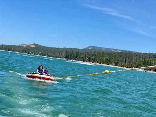 a couple of people on a boat in the water at Glamour Mountain Getaway by Casa Oso with views and spa in Oakhurst