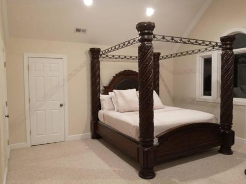 a bedroom with a canopy bed with white pillows at Why Pay Outer Banks (OBX) Beach Prices? Sleeps 9+ in Columbia