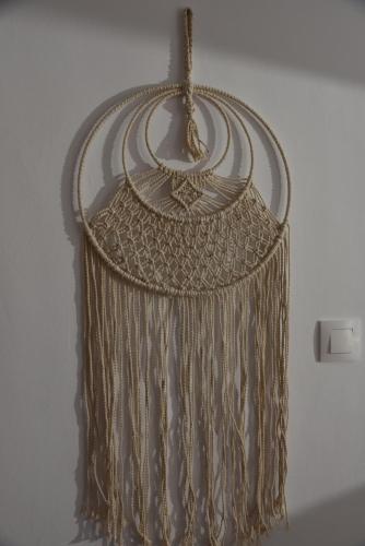 a gold fringe necklace hanging from a wall at J&B Maisonette House in Marmarion