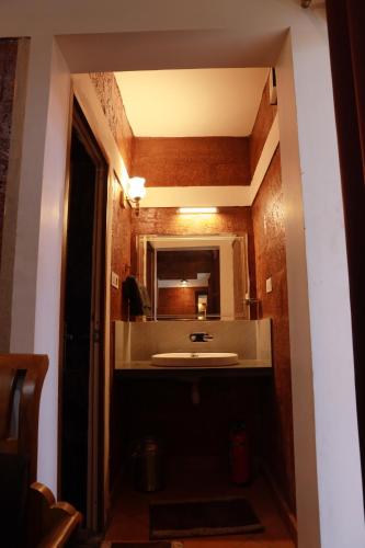 a bathroom with a sink and a mirror at Miracle Holidays in Mananthavady