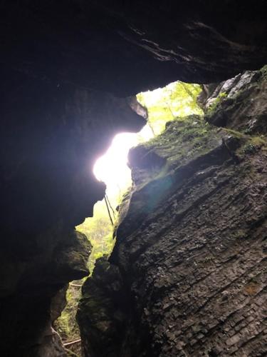 a cave with the sun shining inside of it at Family Home Kobarid - Soca and Nadiza apartament in Kobarid