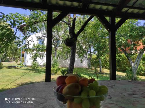 a bowl of fruit sitting on top of a table at Home of nature - kuća prirode in Odžak
