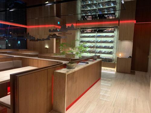 a restaurant with wooden counters and a wine cellar at Hotel SANG SANG in Geoje