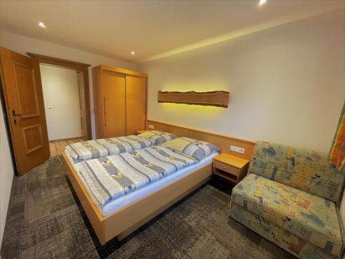 a bedroom with a bed and a couch at Haus Wagrain in Wagrain