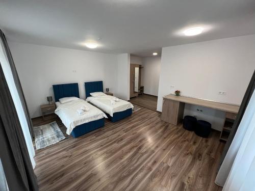 a large room with two beds and a desk at Aparthotel Plevnei4 in Cluj-Napoca