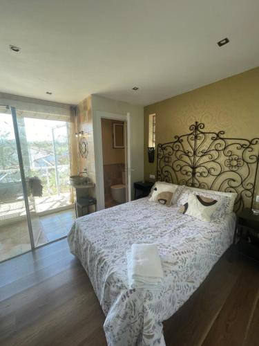 a bedroom with a large bed with a wrought iron headboard at Vistalegre78 in Grado