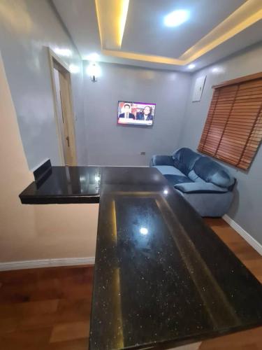 a living room with a table and a couch at Wine House, Maitama, Abuja in Abuja