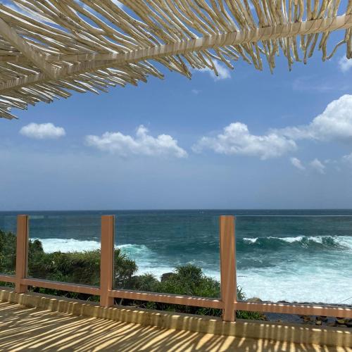 a view of the ocean from a deck at Belika Beach in Hiriketiya