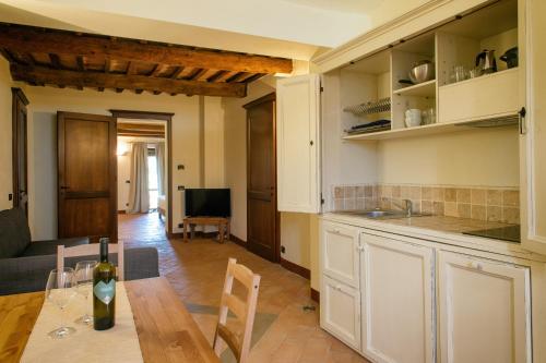a kitchen and living room with a table and a couch at Villaluce Wine Agriturismo in Castiglione del Lago