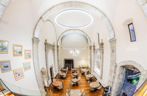 an archway in a building with tables and chairs at Don Paco in Llanes