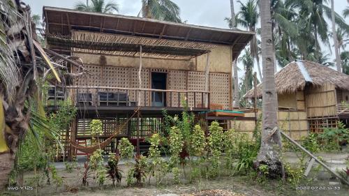 a bamboo house with a thatch roof at Prince John Beachfront Eco Bungalows and Restaurant in San Vicente