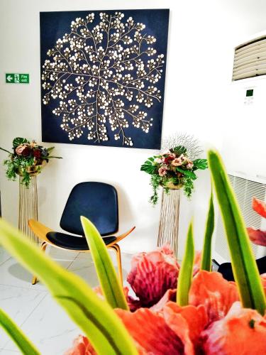a room with a chair and a painting on the wall at CREVICE HOTEL in Davao City