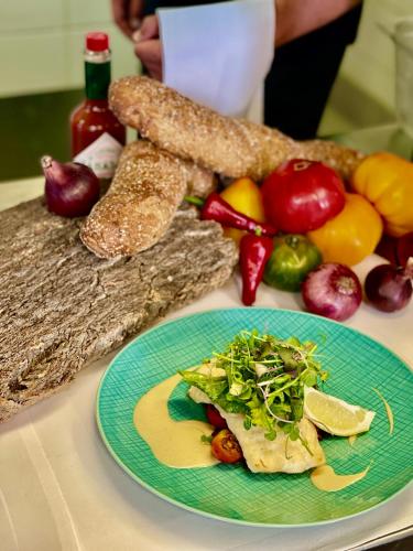 a plate of food on a table with vegetables and bread at Spitzhaus in Radebeul