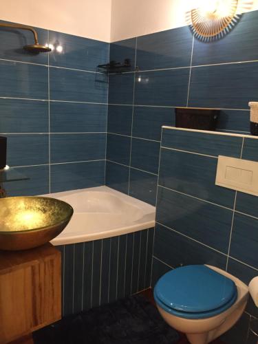 a bathroom with a tub and a toilet and a sink at Merazur in Fréjus
