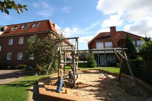 a boy is playing on a playground in a yard at Feriendorf Öfingen 01 in Bad Dürrheim