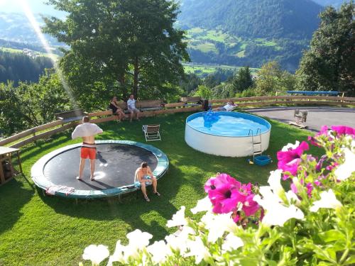 a group of people standing around a swimming pool at Oberstockerhof in Sankt Johann im Pongau
