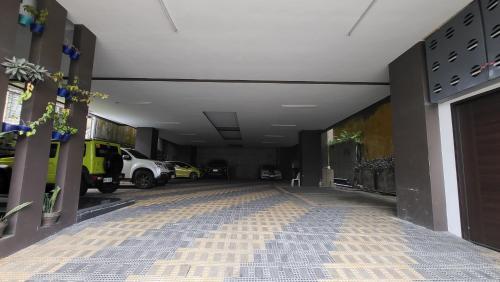 a hallway with cars parked in a parking lot at Finteo Skylands Premium in Baguio