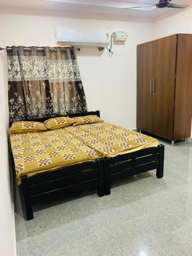 a bedroom with a bed with a curtain and a cabinet at Bay Front Home in Visakhapatnam