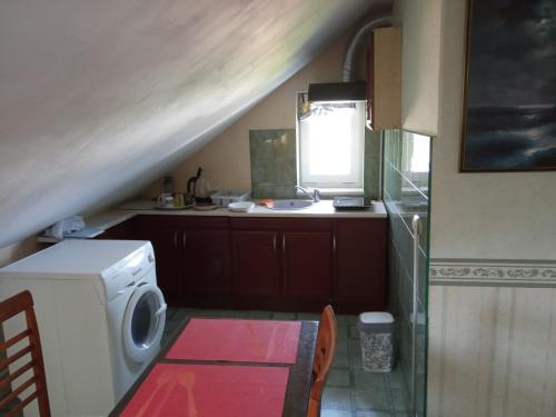 a small kitchen with a washing machine and a sink at Apartment in Kauguri in Jūrmala