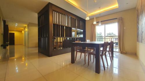 a dining room with a black table and chairs at Gold Coast Morib Themepark View Studio in Banting