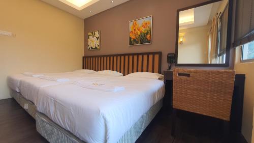 a bedroom with two beds and a mirror at Gold Coast Morib Themepark View Studio in Banting