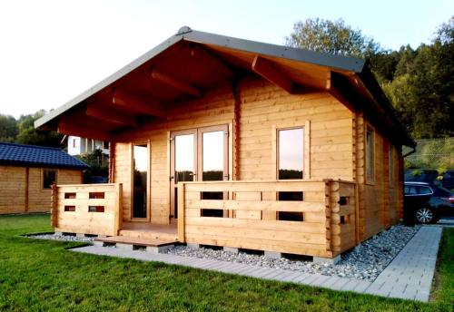 a small wooden cabin with a pitched roof at Domki Na Stoku Laworty in Ustrzyki Dolne