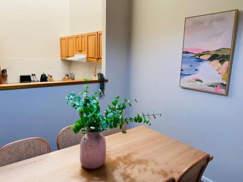 a vase sitting on a wooden table in a kitchen at Family Favourite, Spacious 2 Bedroom Unit in Young