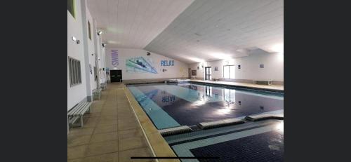 a large indoor swimming pool in a building at 128 Hengar Manor in Bodmin