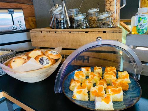a plate of food on a table with a bowl of bread at Hotel Královka in Bedřichov