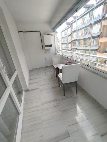 a room with a table and chairs and a window at Bolu Deluxe Otel in Bolu