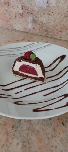 a piece of cake on a white plate with a fork at Comorebi Provence in Entrecasteaux