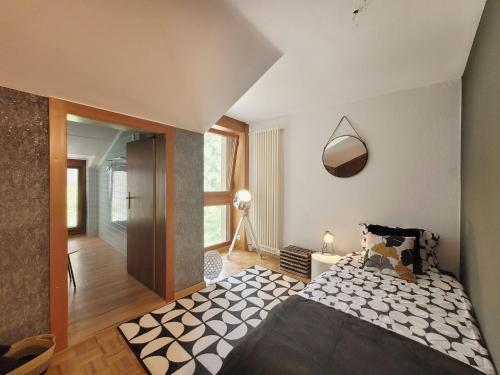 a bedroom with a large bed and a hallway at L'AvantGardiste, Spacious 6 bedrooms duplex, panoramic view in Crans-Montana