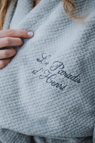 a woman holding a sweater with the words no grandma ever at Le Paradis d'Henri in Hannut