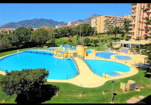 a large swimming pool in a park in a city at Benaldream in Benalmádena