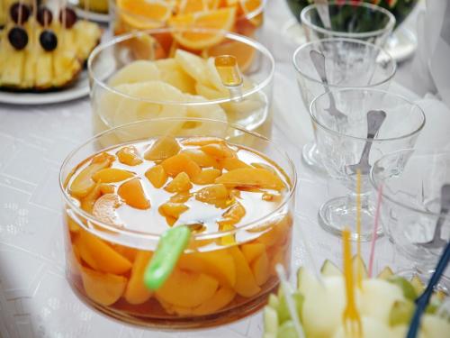 a bowl of fruit with whipped cream and oranges on a table at Hotel Zajazdu w Ostrzeszowie in Ostrzeszów