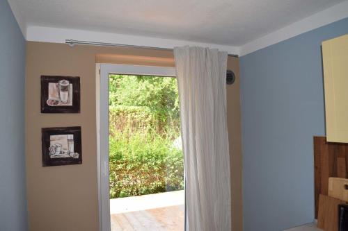a room with a sliding glass door with a window at Obstkorb Stralsund in Stralsund