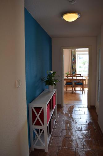 a room with a blue wall and a table with a plant at Obstkorb Stralsund in Stralsund