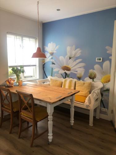 a living room with a table and a couch at Appartement 4 Seasons Katwijk aan Zee in Katwijk aan Zee
