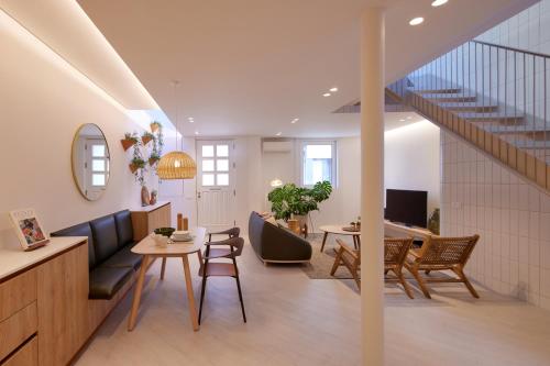 a living room with a couch and a table at Bougainvillea 33 by My Cozy Home in Faro